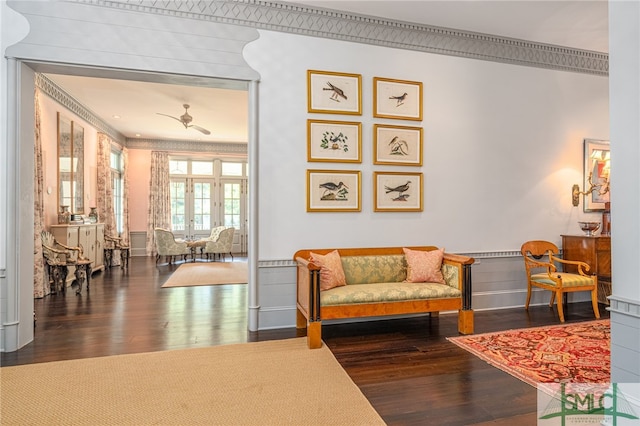 sitting room with ceiling fan, dark hardwood / wood-style flooring, and ornamental molding