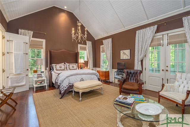 bedroom featuring an inviting chandelier, french doors, dark hardwood / wood-style floors, high vaulted ceiling, and ornamental molding