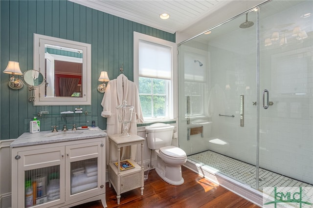 bathroom featuring vanity, a shower with door, toilet, and hardwood / wood-style floors