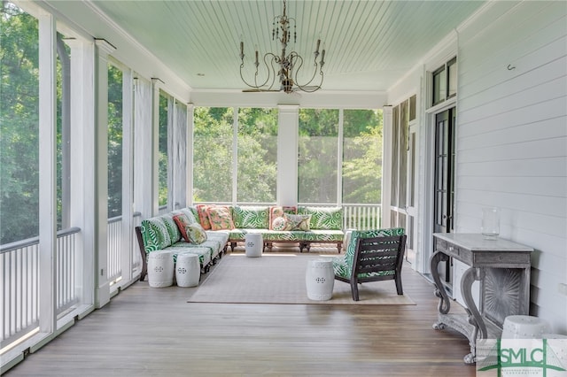 sunroom / solarium with a notable chandelier