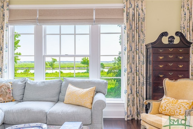 sunroom / solarium featuring a water view