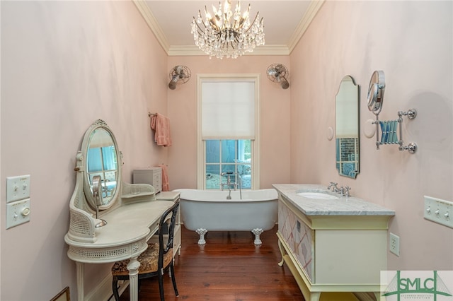 bathroom featuring hardwood / wood-style flooring, a bath, a chandelier, crown molding, and vanity