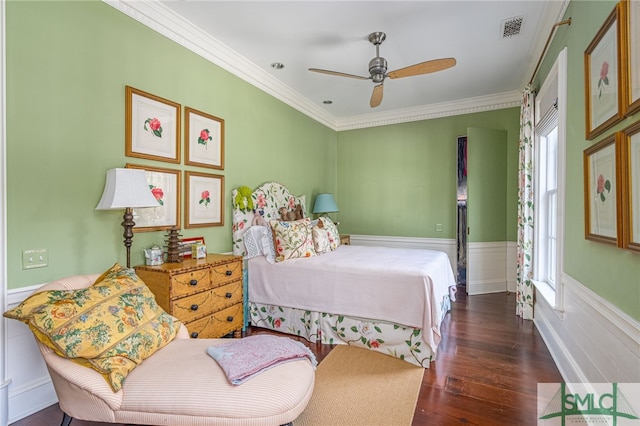 bedroom with ornamental molding, dark wood-type flooring, and ceiling fan