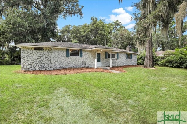 rear view of house with a yard