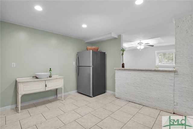 kitchen with white cabinetry, ceiling fan, and stainless steel refrigerator