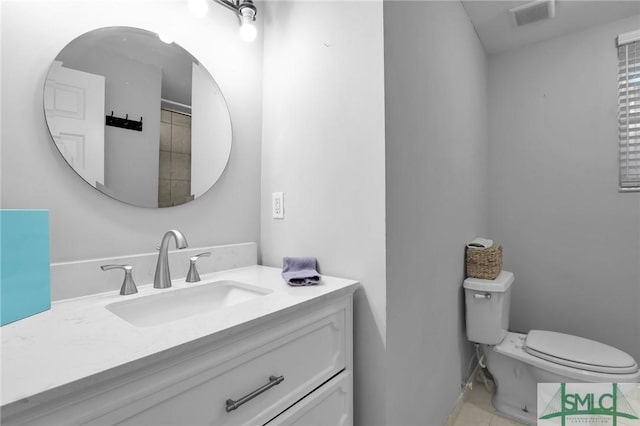 bathroom with tile patterned floors, toilet, and vanity