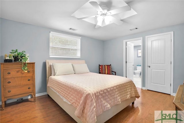 bedroom with ceiling fan, light hardwood / wood-style floors, and ensuite bath