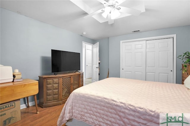 bedroom with a closet, ceiling fan, and hardwood / wood-style floors