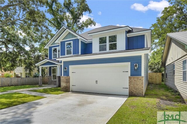 view of front of property with a garage and a front lawn