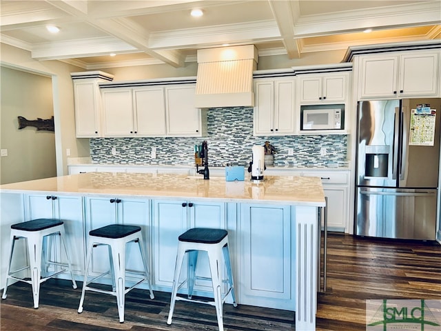 kitchen featuring white microwave, coffered ceiling, stainless steel fridge with ice dispenser, and dark wood-type flooring