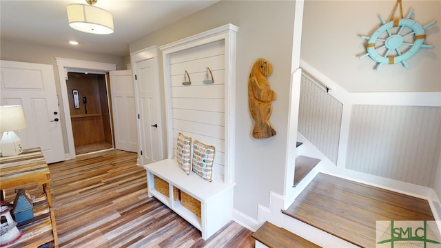 mudroom with wood finished floors and baseboards