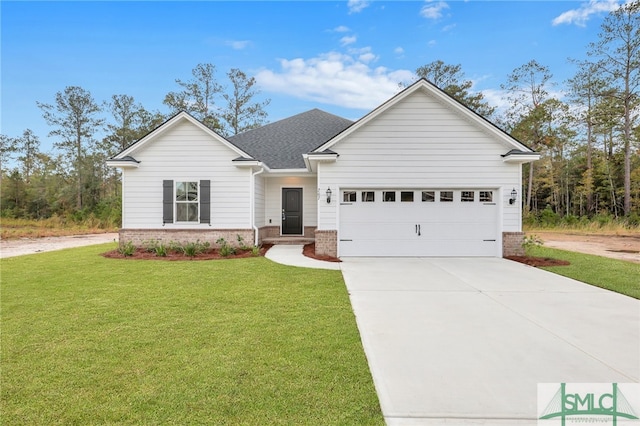 view of front of property featuring a garage and a front lawn