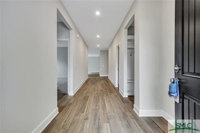 hallway with light hardwood / wood-style flooring