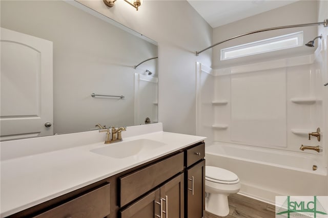 full bathroom featuring shower / bath combination, vanity, hardwood / wood-style flooring, and toilet