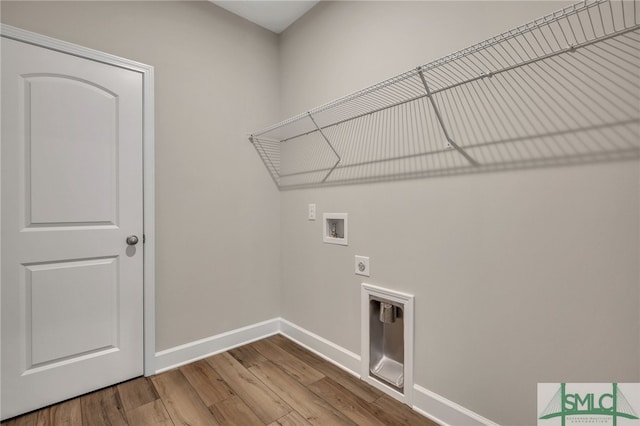 laundry area featuring electric dryer hookup, hookup for a washing machine, and hardwood / wood-style floors