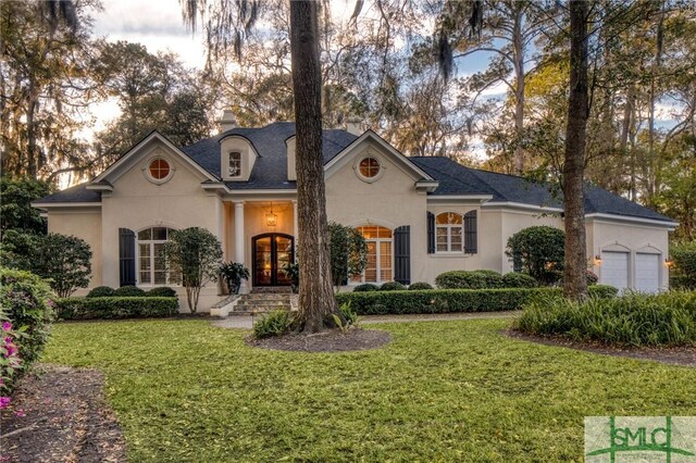 view of front of property with a garage and a front yard