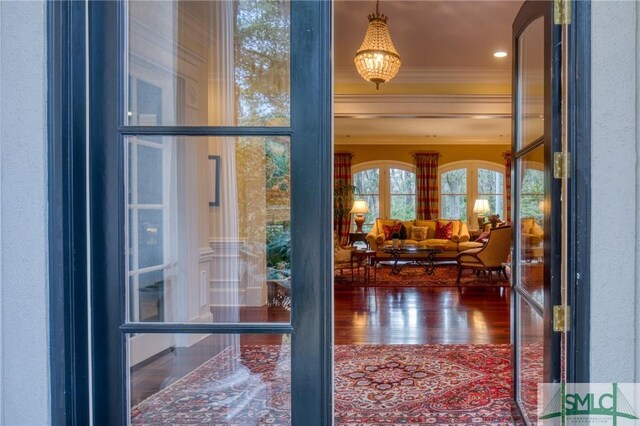 corridor featuring wood-type flooring and ornamental molding