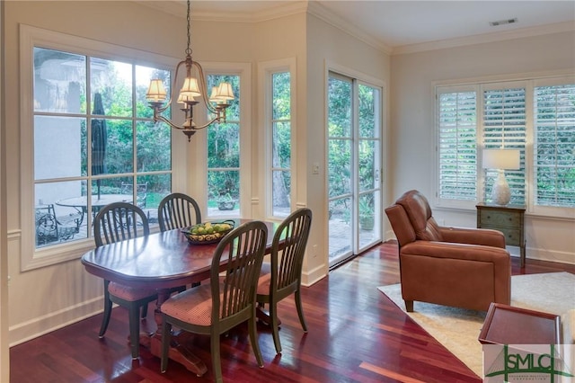 dining space with a chandelier, ornamental molding, dark wood-style flooring, and visible vents