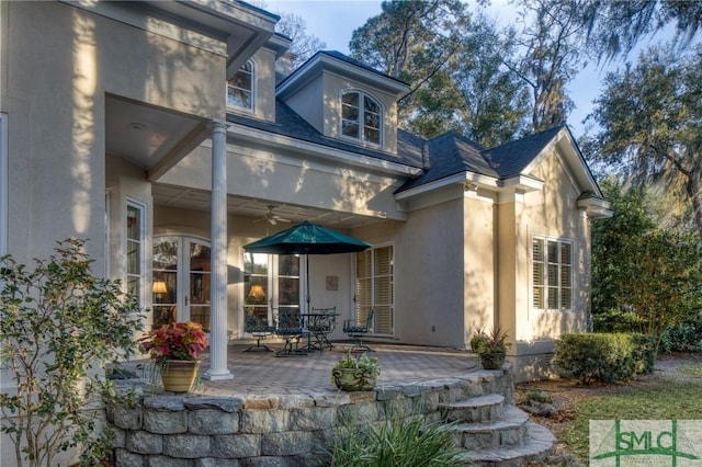 rear view of property with ceiling fan, french doors, a patio, and stucco siding