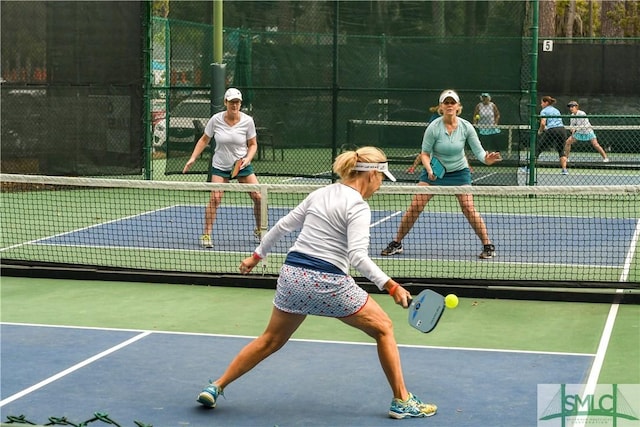 view of tennis court featuring fence