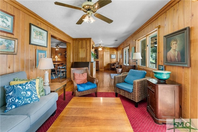 living room with dark hardwood / wood-style floors and wood walls