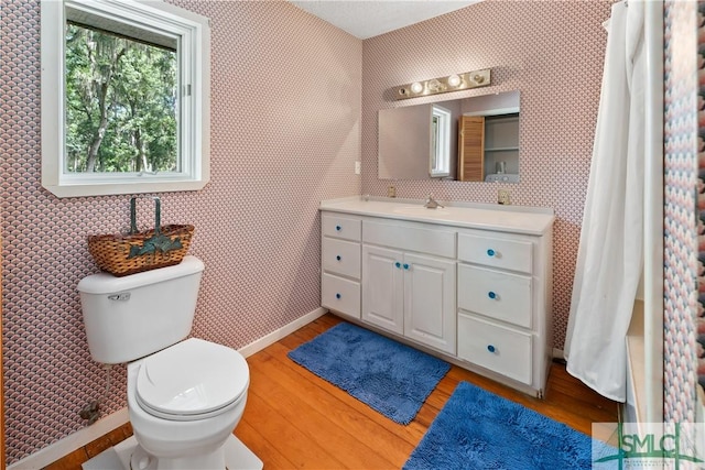 bathroom featuring hardwood / wood-style flooring, vanity, and toilet