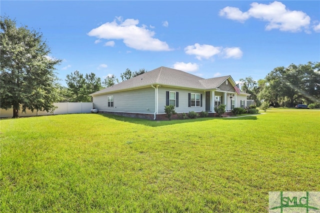 view of side of home with a lawn