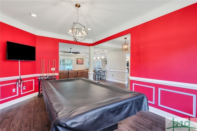 rec room featuring dark wood-type flooring, ceiling fan with notable chandelier, crown molding, and billiards