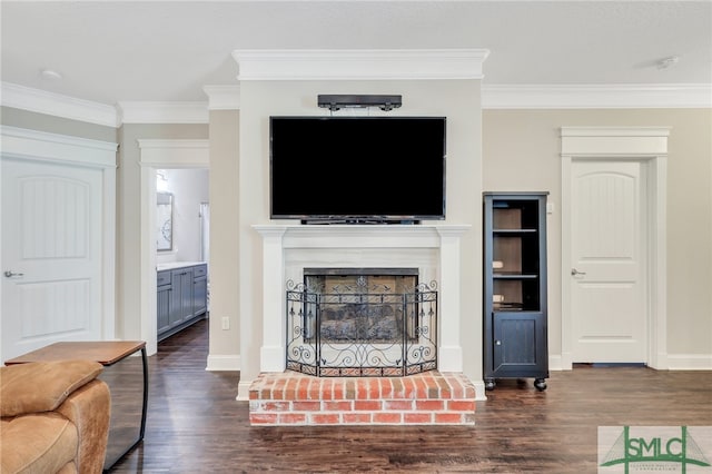 living room featuring ornamental molding, a brick fireplace, and dark wood-type flooring