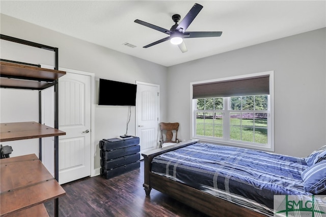 bedroom with dark wood-type flooring and ceiling fan