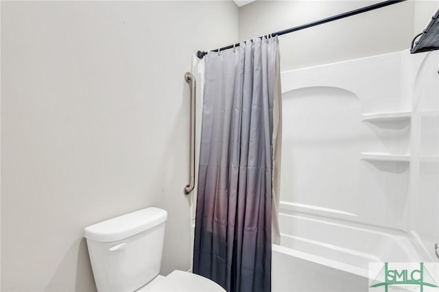 bathroom featuring shower / bath combination with curtain and toilet