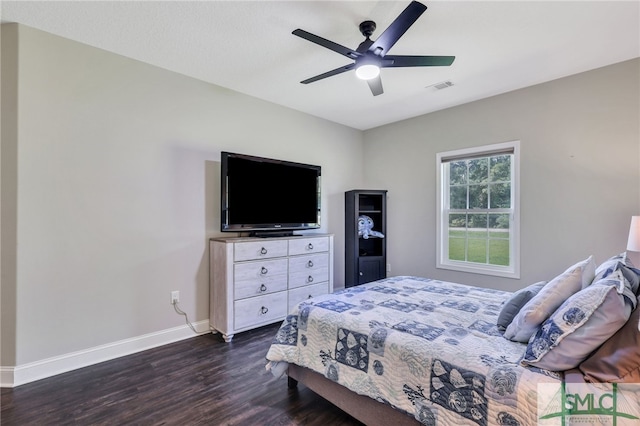 bedroom with dark hardwood / wood-style floors and ceiling fan