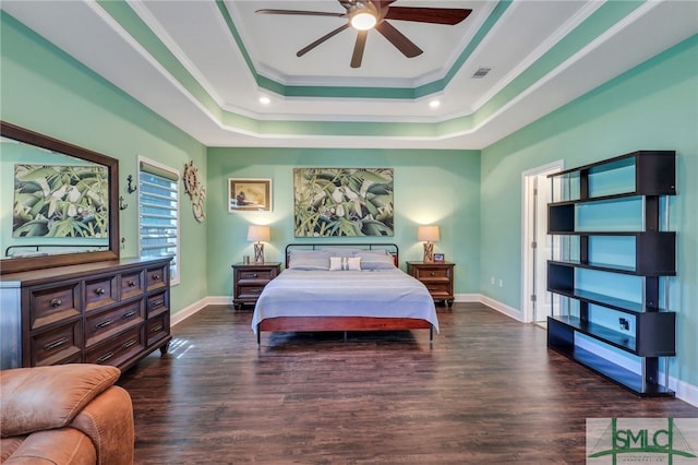 bedroom with ceiling fan, crown molding, a tray ceiling, and hardwood / wood-style floors