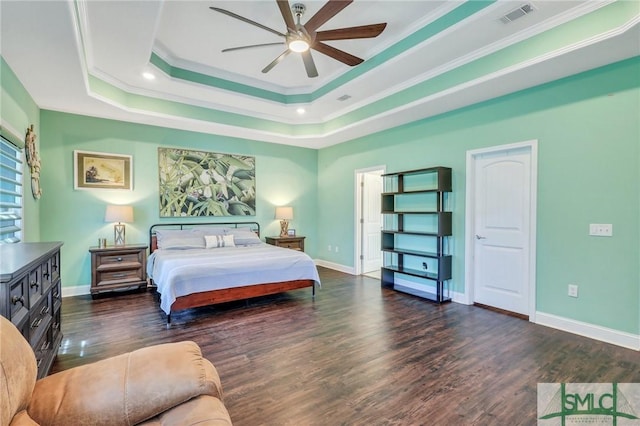 bedroom featuring a raised ceiling, ornamental molding, dark hardwood / wood-style floors, and ceiling fan