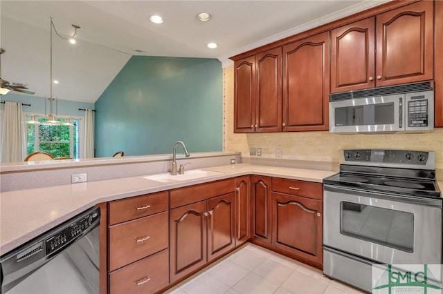 kitchen with lofted ceiling, stainless steel appliances, sink, backsplash, and light tile patterned floors