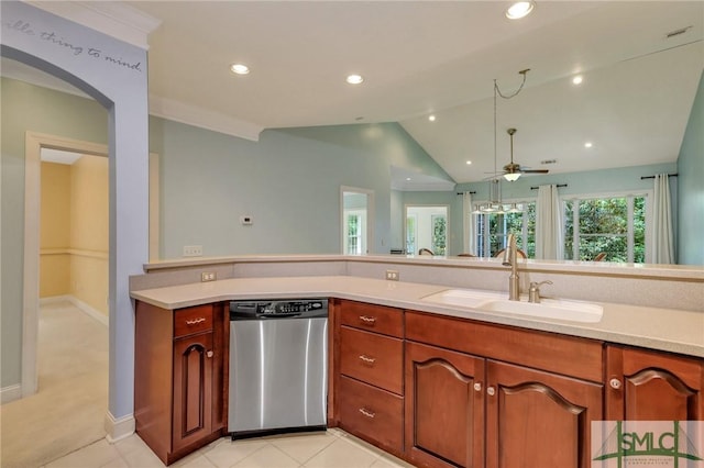 kitchen with sink, dishwasher, light tile patterned floors, and vaulted ceiling