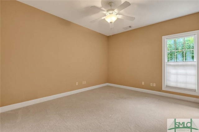 carpeted spare room featuring ceiling fan