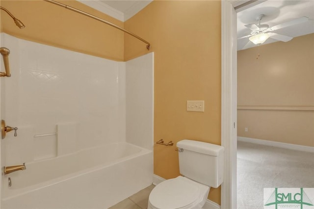 bathroom featuring washtub / shower combination, toilet, ceiling fan, and tile patterned flooring