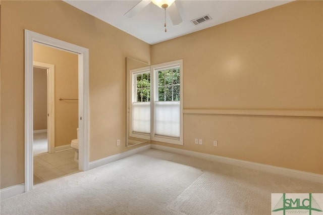 carpeted spare room featuring ceiling fan