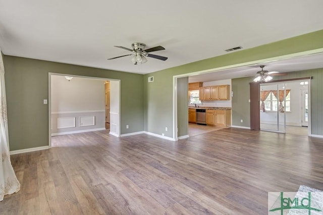 unfurnished living room featuring ceiling fan and light hardwood / wood-style flooring