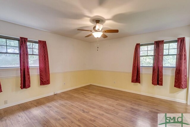 empty room featuring ceiling fan and hardwood / wood-style floors