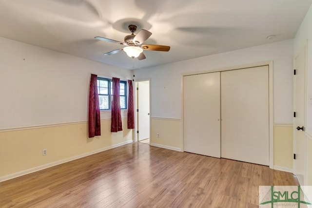 unfurnished bedroom featuring light hardwood / wood-style floors, a closet, and ceiling fan