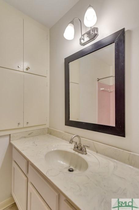 bathroom with vanity and a shower