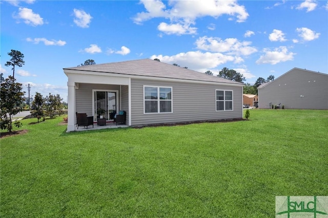 back of house featuring a patio and a lawn