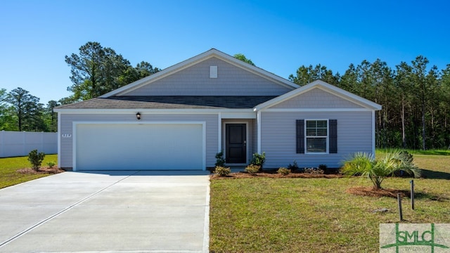 view of front of house featuring a garage and a front yard