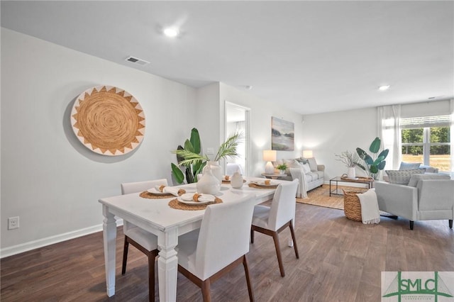 dining space with dark wood-type flooring