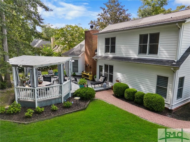 back of house featuring a gazebo, a yard, and a deck