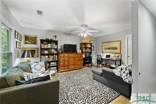 living room with ceiling fan and light hardwood / wood-style floors