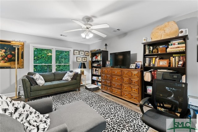 living room with ceiling fan and wood-type flooring