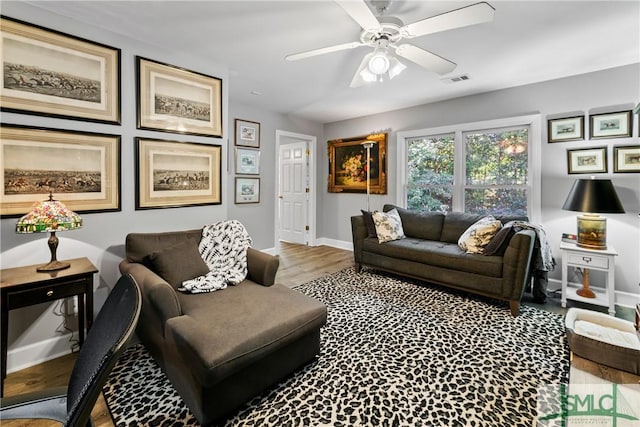 living room featuring hardwood / wood-style flooring and ceiling fan